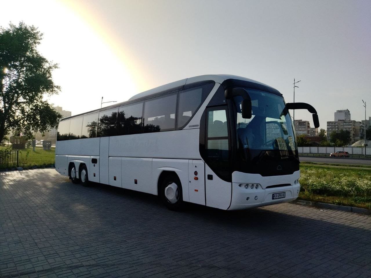 White Neoplan Tourliner 70-seat coach, front three-quarter view