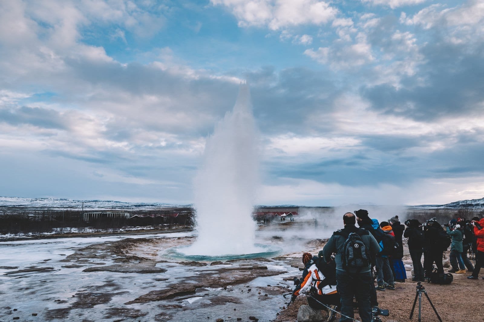 Steam rising from a turquoise hot spring at the Geysir geothermal area